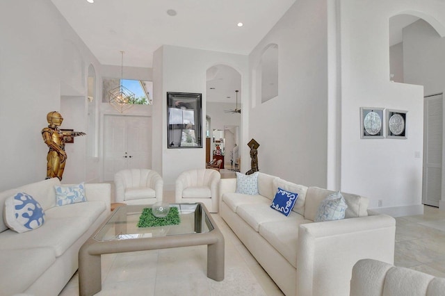 living room featuring a high ceiling and light tile patterned floors