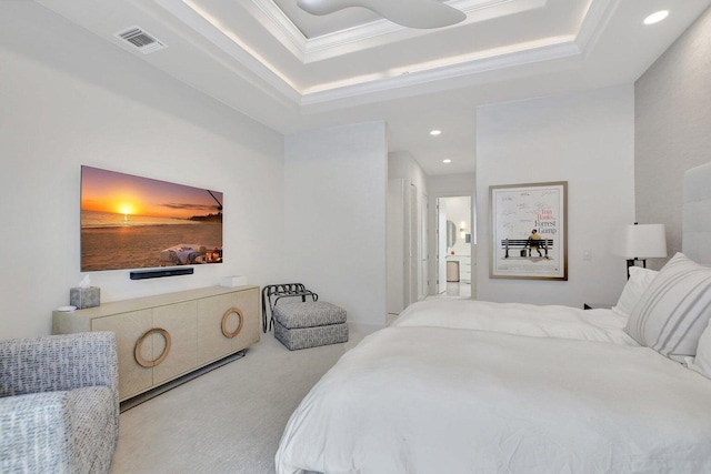 bedroom with a raised ceiling, crown molding, and light colored carpet