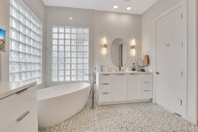 bathroom featuring vanity and a bath