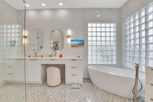 bathroom with vanity, a bath, and tile patterned flooring