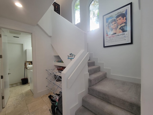 staircase with tile patterned floors