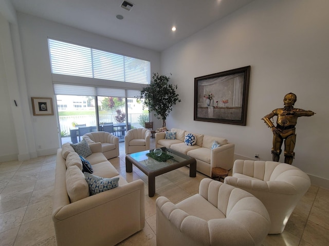 living room featuring a high ceiling