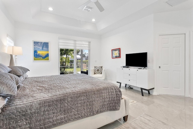 bedroom featuring ceiling fan, a tray ceiling, and access to outside