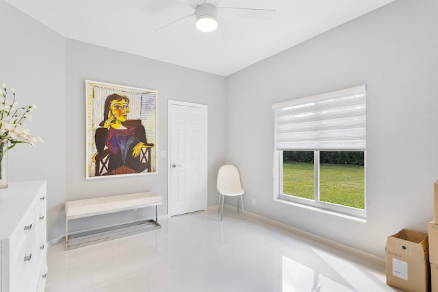 living area featuring ceiling fan and light tile patterned flooring