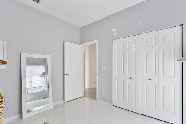 unfurnished bedroom with a closet and light tile patterned floors