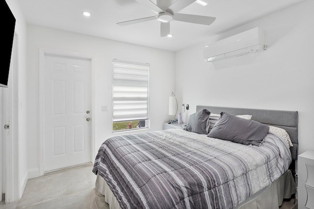 bedroom with a wall mounted air conditioner and ceiling fan