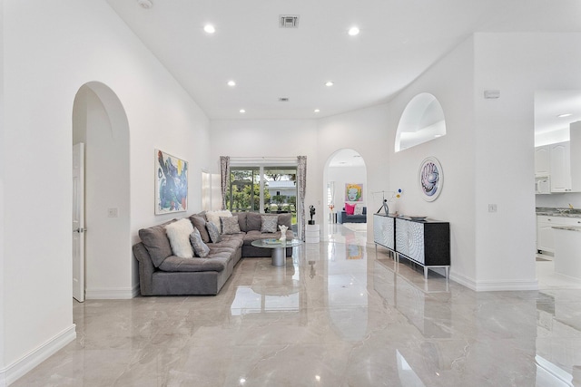 living room with a towering ceiling