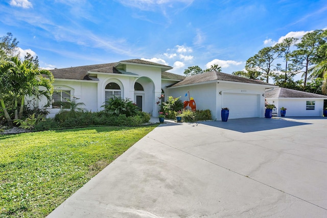 mediterranean / spanish-style house featuring a garage and a front yard