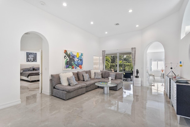 living room featuring a towering ceiling