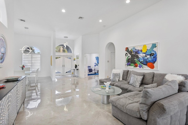 living room featuring a high ceiling and french doors