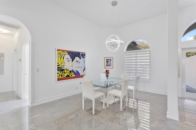 dining room featuring a high ceiling and an inviting chandelier