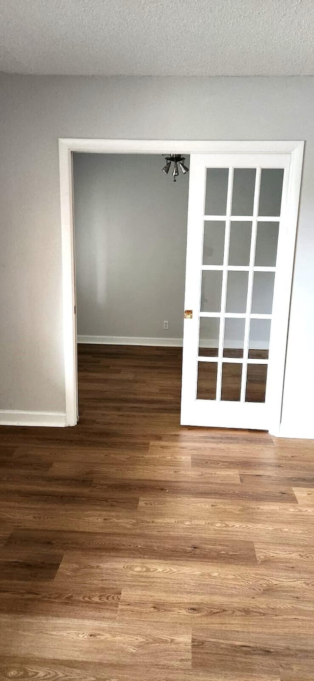 spare room featuring hardwood / wood-style floors and a textured ceiling