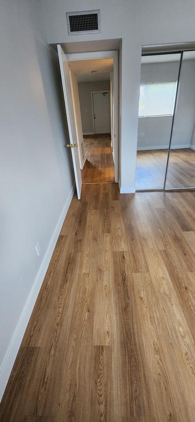 hall with light hardwood / wood-style floors