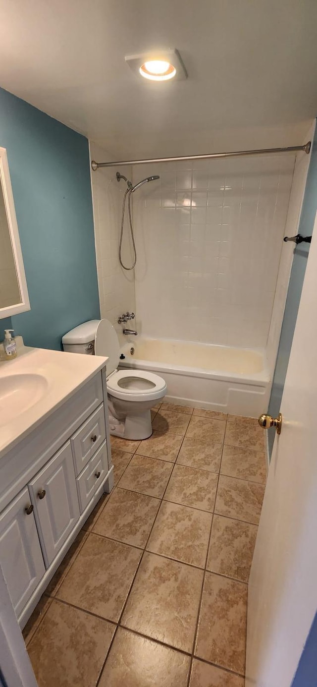 full bathroom with tile patterned floors, vanity, toilet, and tiled shower / bath combo