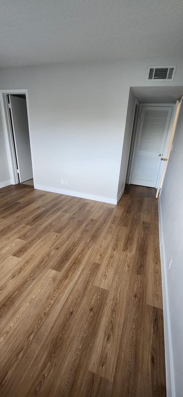 empty room featuring hardwood / wood-style floors and a textured ceiling