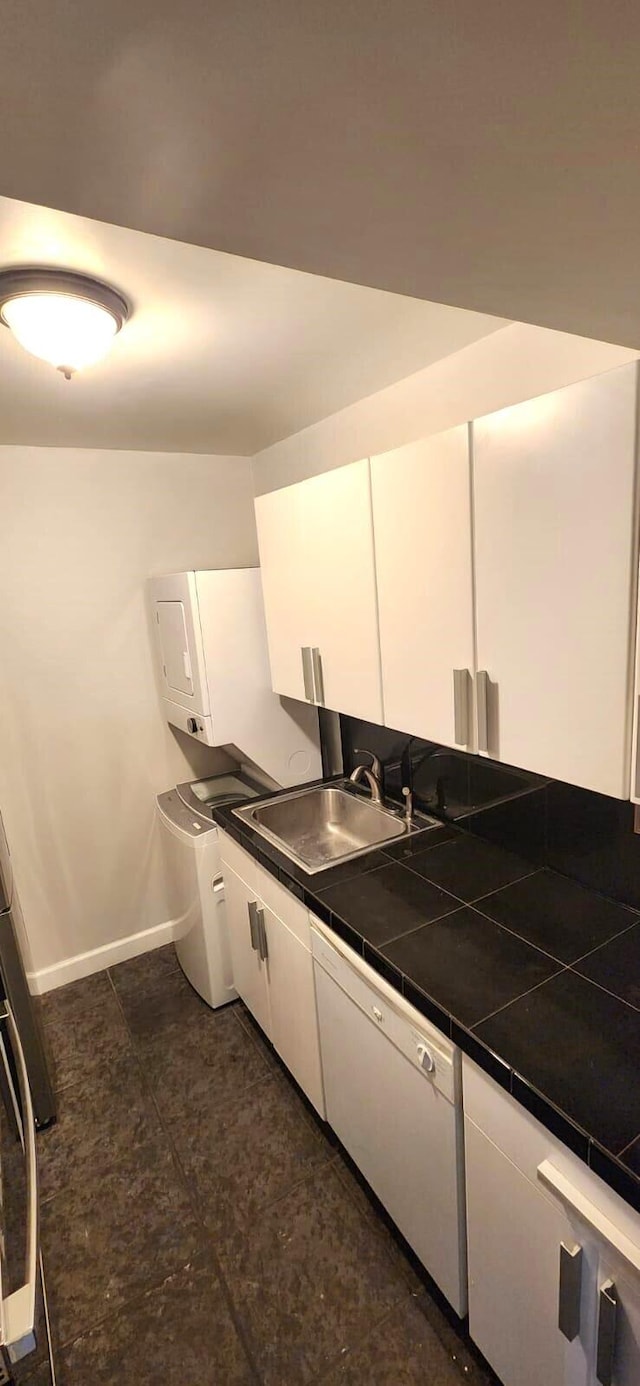 kitchen with sink, tile countertops, and white cabinets