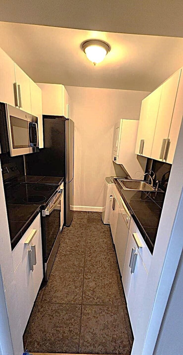 kitchen with white cabinetry, electric range oven, and sink