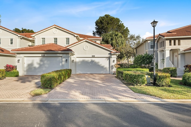 mediterranean / spanish-style home with a garage