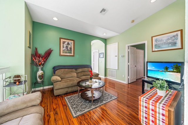 living room with dark hardwood / wood-style flooring, radiator heating unit, and vaulted ceiling