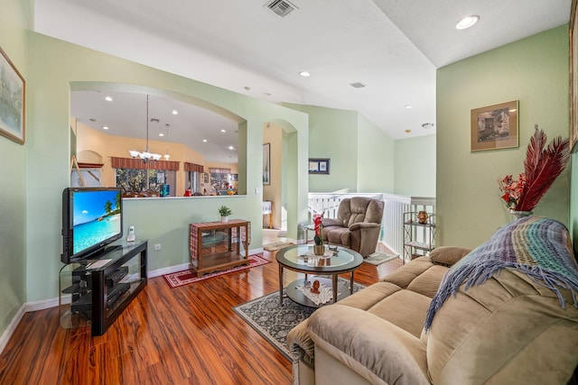 living room featuring wood-type flooring and a chandelier