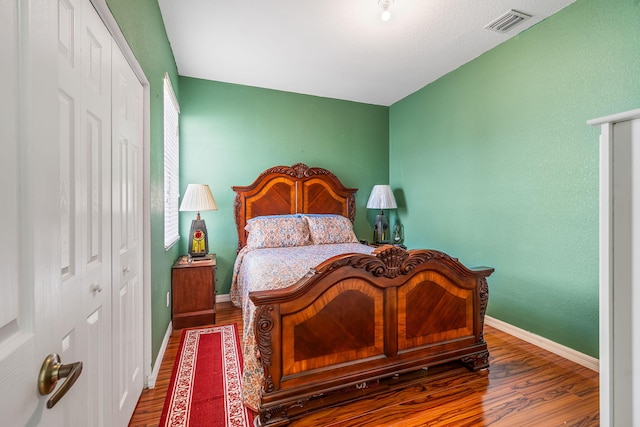 bedroom featuring wood-type flooring and a closet