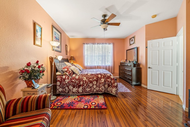 bedroom with hardwood / wood-style floors and ceiling fan