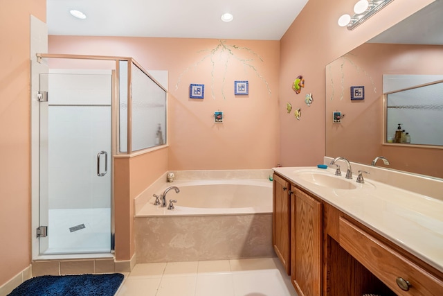 bathroom with tile patterned floors, vanity, and separate shower and tub