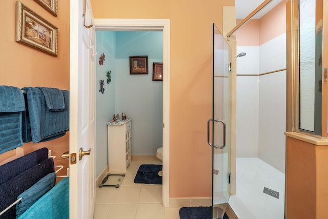 bathroom featuring walk in shower, tile patterned floors, and toilet