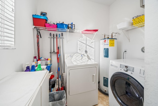 laundry area with water heater and independent washer and dryer