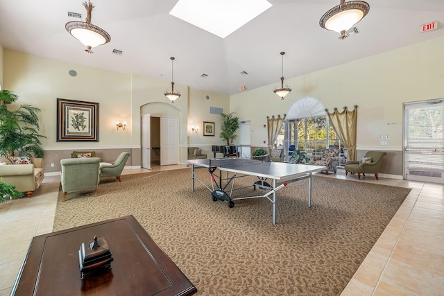 recreation room featuring tile patterned floors and a skylight