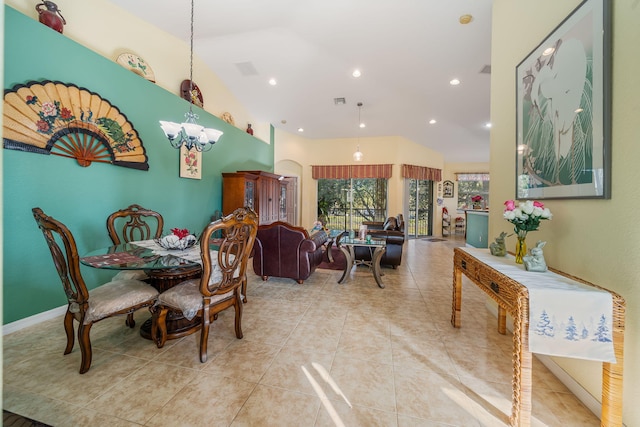 dining room with lofted ceiling, a notable chandelier, and light tile patterned flooring