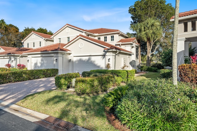 mediterranean / spanish-style house featuring a front yard