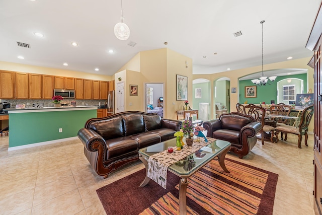 living room with light tile patterned floors and a chandelier