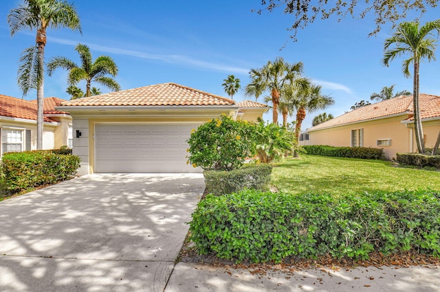 mediterranean / spanish house featuring a garage and a front yard