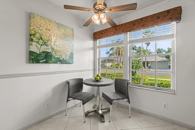 sitting room with light tile patterned floors, a textured ceiling, and ceiling fan