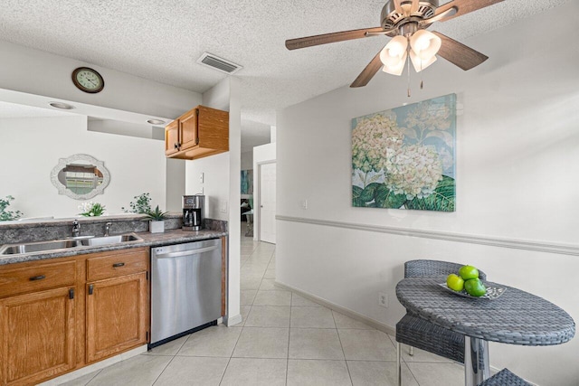 kitchen featuring sink, a textured ceiling, light tile patterned floors, stainless steel dishwasher, and ceiling fan