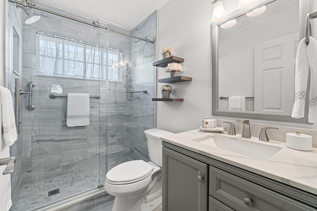 bathroom with vanity, an enclosed shower, and toilet