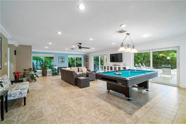 recreation room with a wealth of natural light, ornamental molding, and a textured ceiling