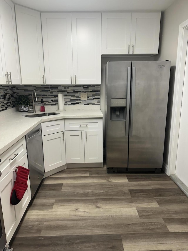 kitchen with white cabinetry, appliances with stainless steel finishes, sink, and dark wood-type flooring