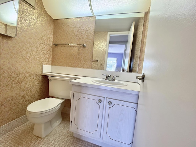 bathroom featuring vanity, tile patterned floors, and toilet