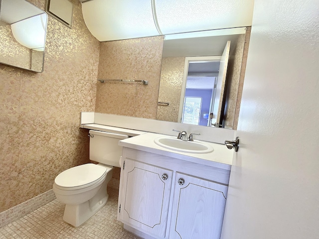 bathroom featuring vanity, toilet, and tile patterned flooring