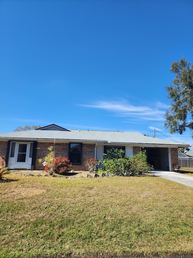 ranch-style home with a front lawn