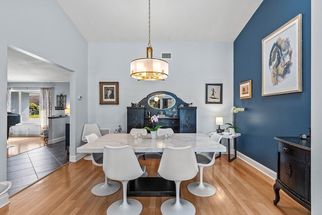 dining space with light hardwood / wood-style floors