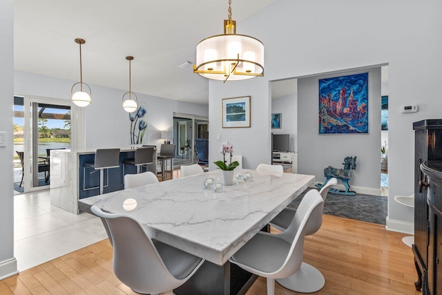 dining space with light hardwood / wood-style floors