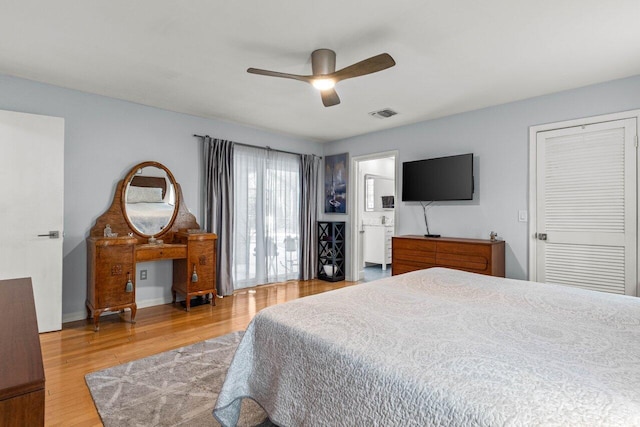 bedroom featuring hardwood / wood-style flooring, ceiling fan, and ensuite bathroom