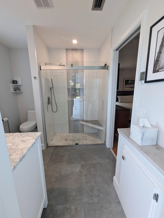 bathroom with vanity, an enclosed shower, and toilet