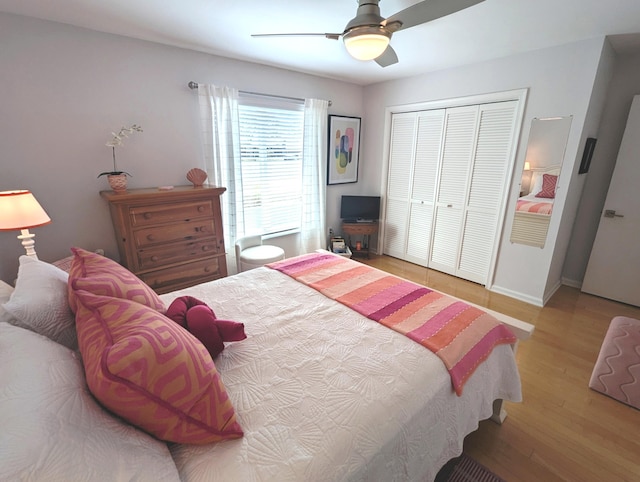 bedroom with hardwood / wood-style floors, a closet, and ceiling fan