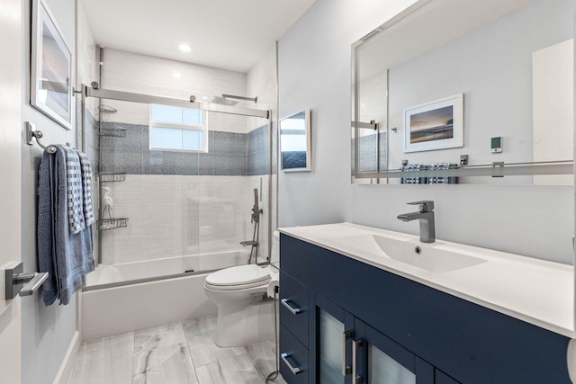 full bathroom with vanity, bath / shower combo with glass door, and toilet