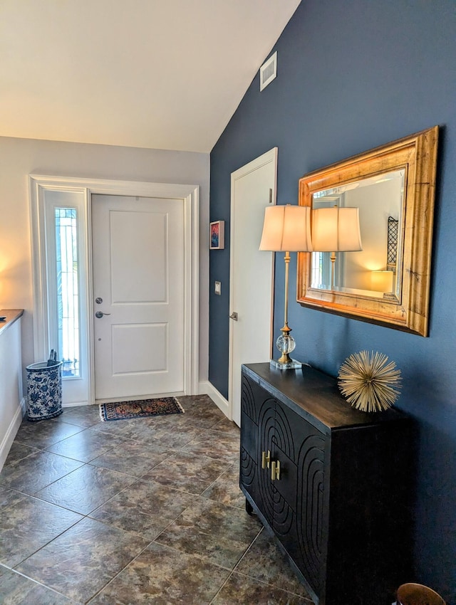 entryway featuring lofted ceiling