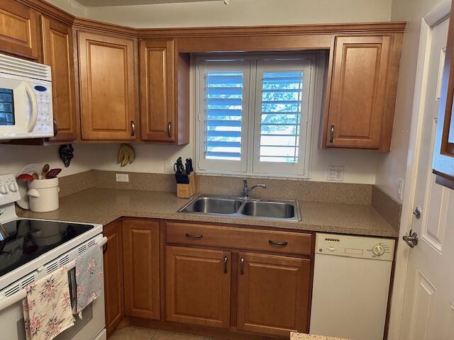 kitchen with sink and white appliances